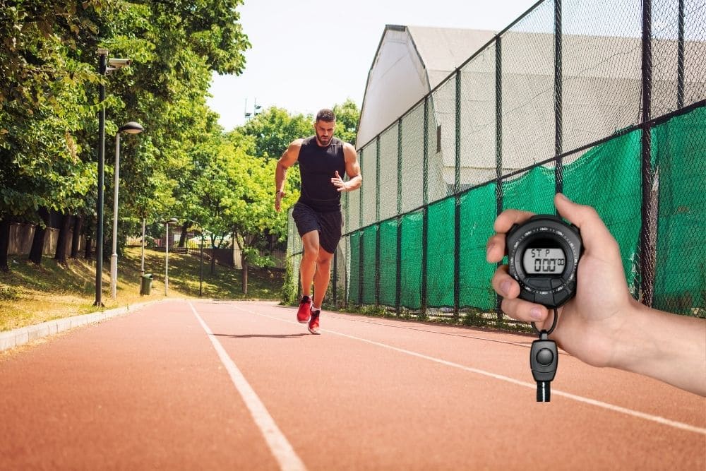 man practicing running with a stopwatch to record his progress