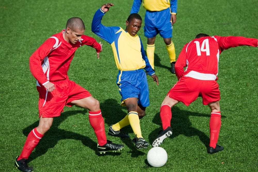 central forward dribbling the ball throught his opponents