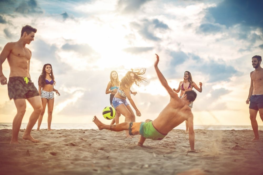 seven soccer players playing beach soccer
