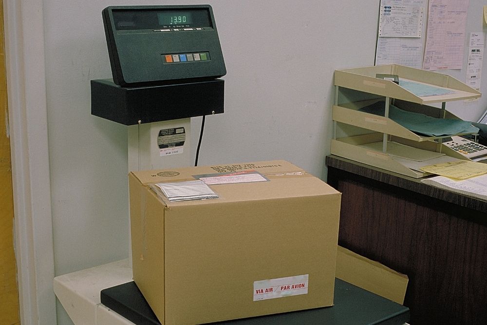 weighing parcel on scale in shipping office