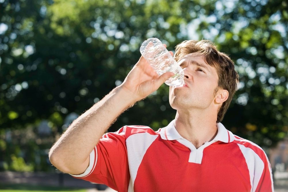 soccer player drinking a bottle of water