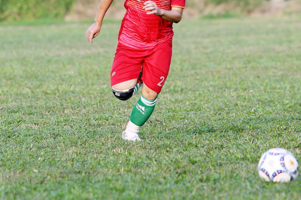 Soccer player with the short above his knee and are printing