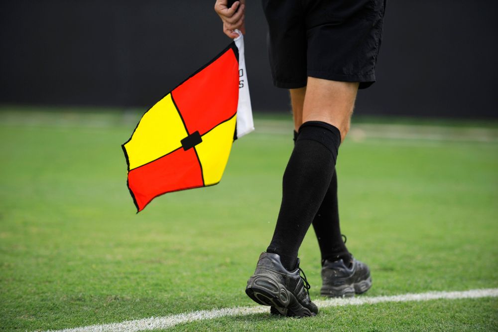 Soccer referee running on the pitch