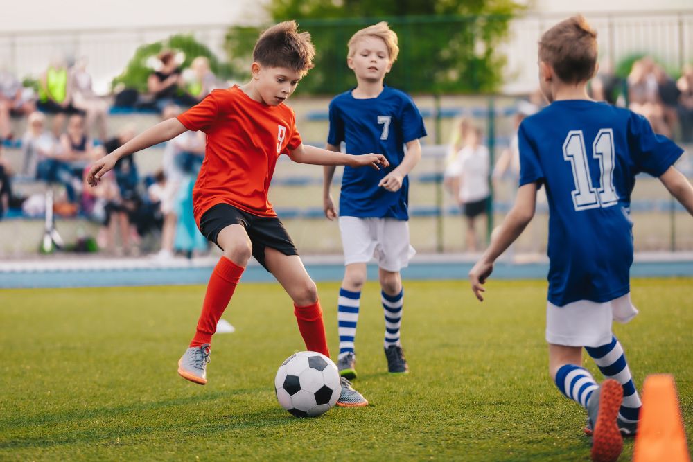 Young soccer players are fight for the ball on the field