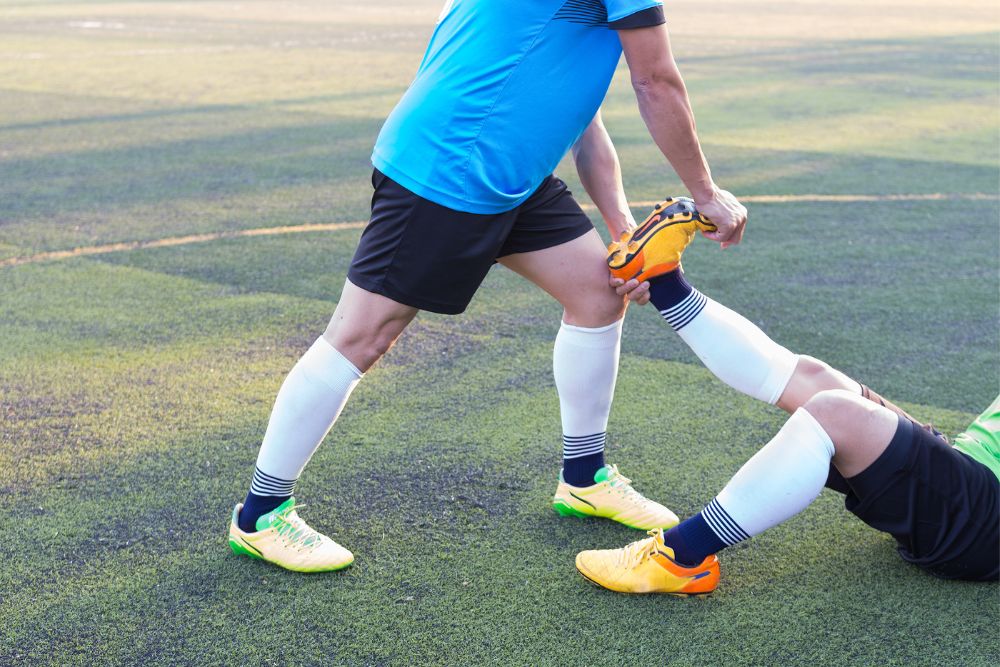 a healthcare worker helps soccer player with ankle sprains