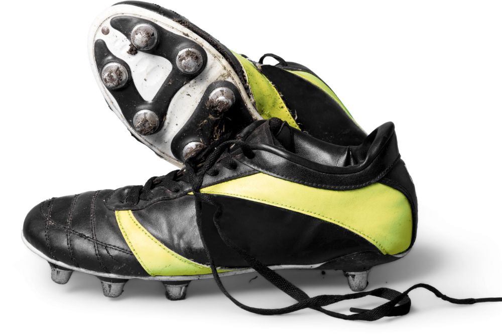 a pair of leather soccer cleats unlaced