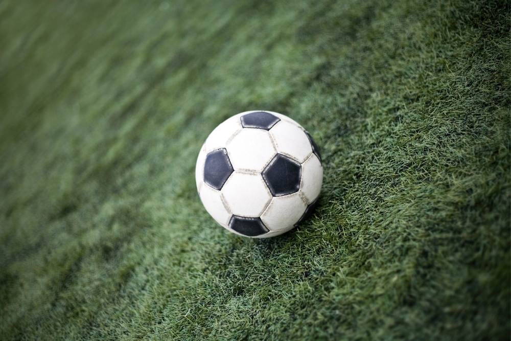 old soccer ball on the pitch