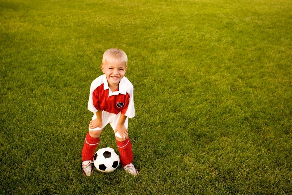 Kid soccer player is smilling