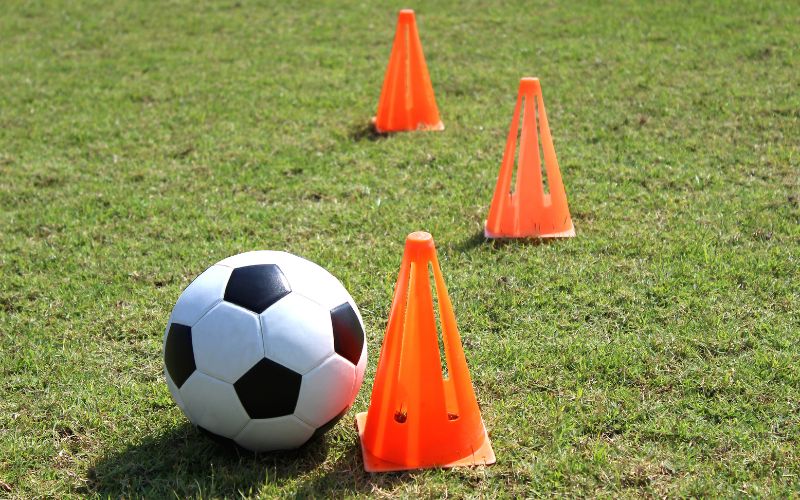Soccer ball and cones on the field